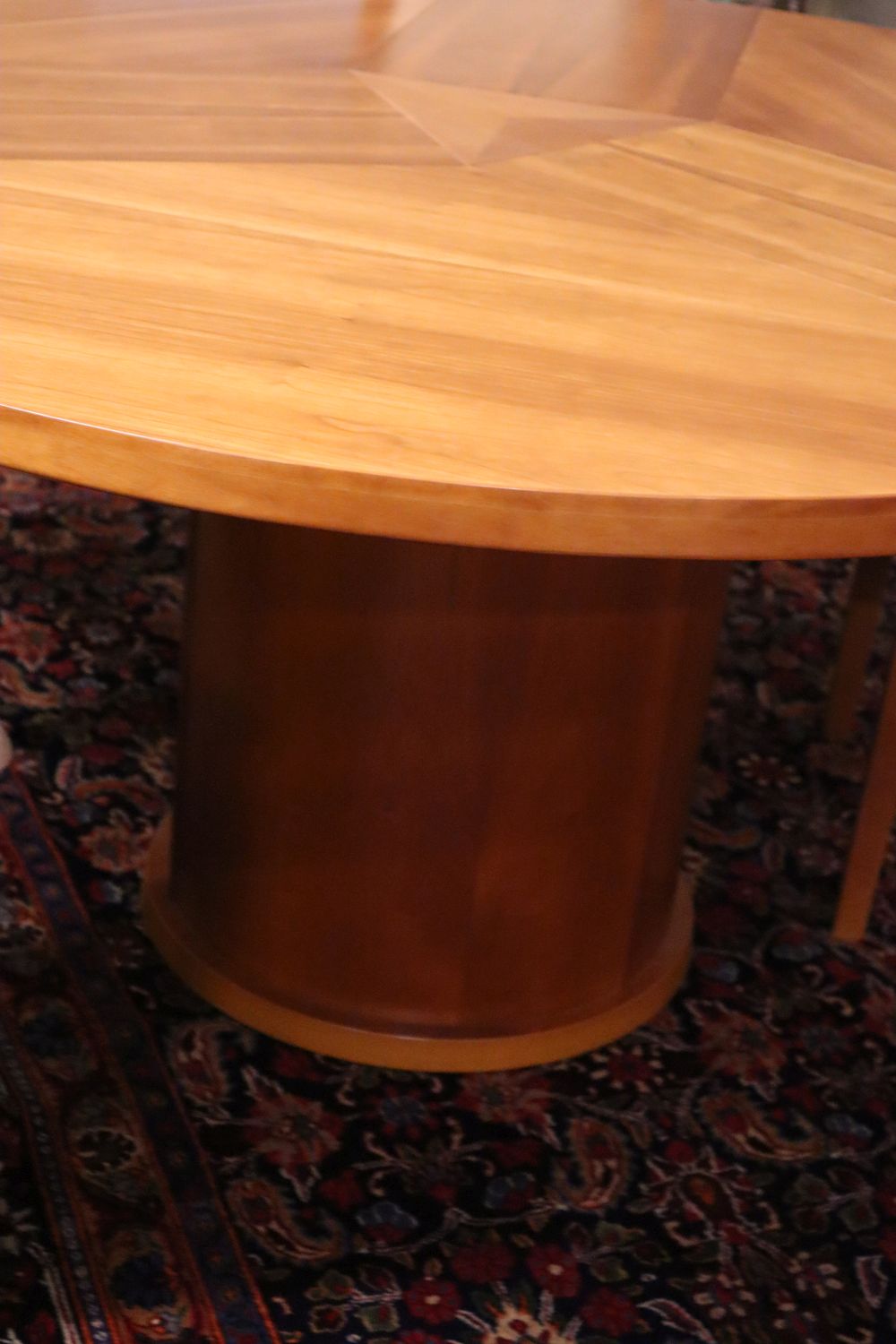 Skovby, Denmark, a patent cherrywood revolving expanding circular table with three integral leaves, width 145cm, height 73cm and a set